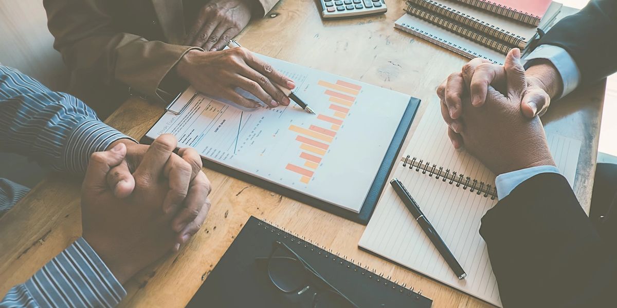 Colleagues reviewing financial charts at a desk